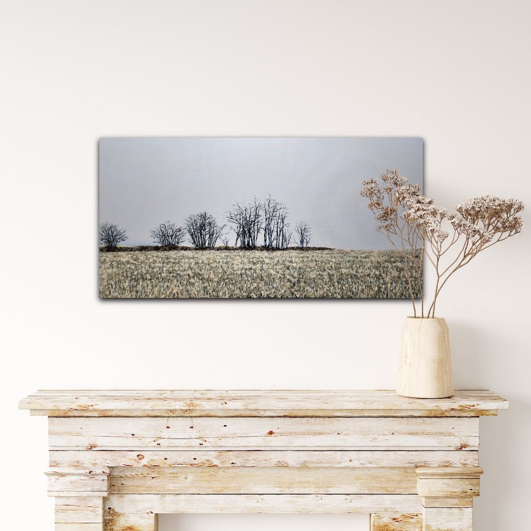 Finter 18"x36" oil painting of a field with winter trees and a blue-grey horizon over a white wood mantel