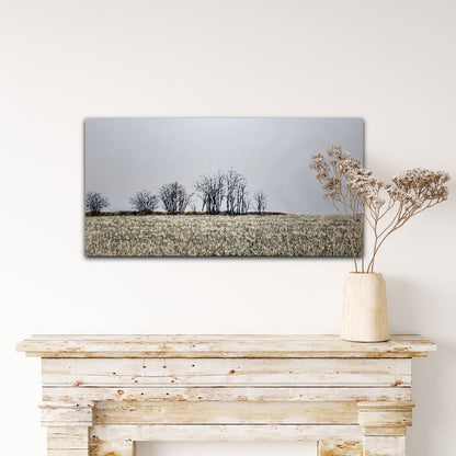 Finter 18"x36" oil painting of a field with winter trees and a blue-grey horizon over a white wood mantel