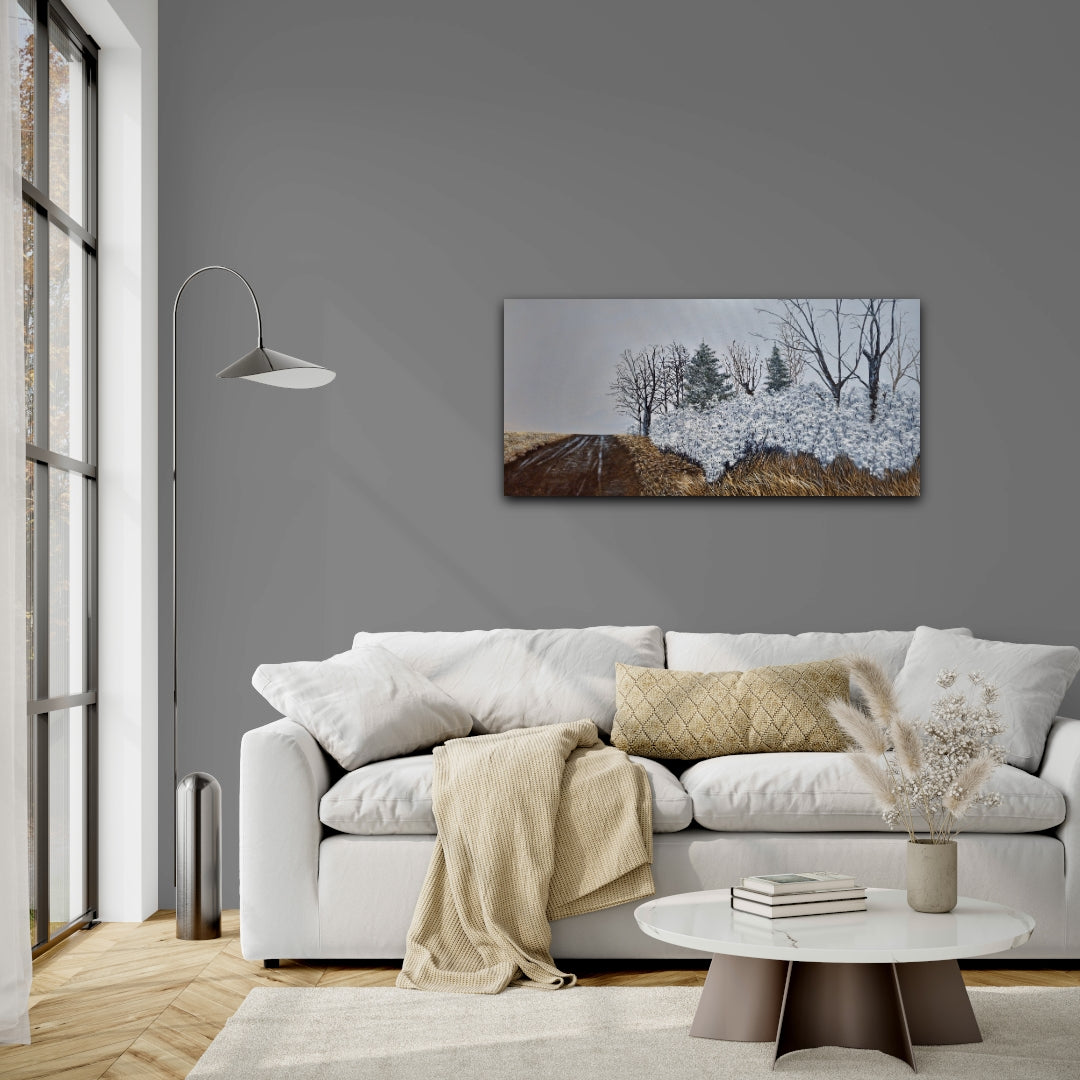 Modern living room with a gray wall, white sofa, and winter road landscape painting.