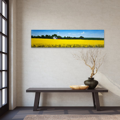 Panoramic landscape painting of a yellow field on a wall above a wooden bench with decorative items.