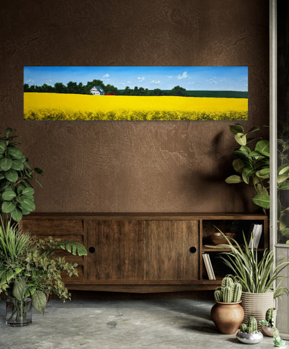 Large painting displaying a scenic view of a yellow field with trees, placed in a room with plants and wooden furniture.