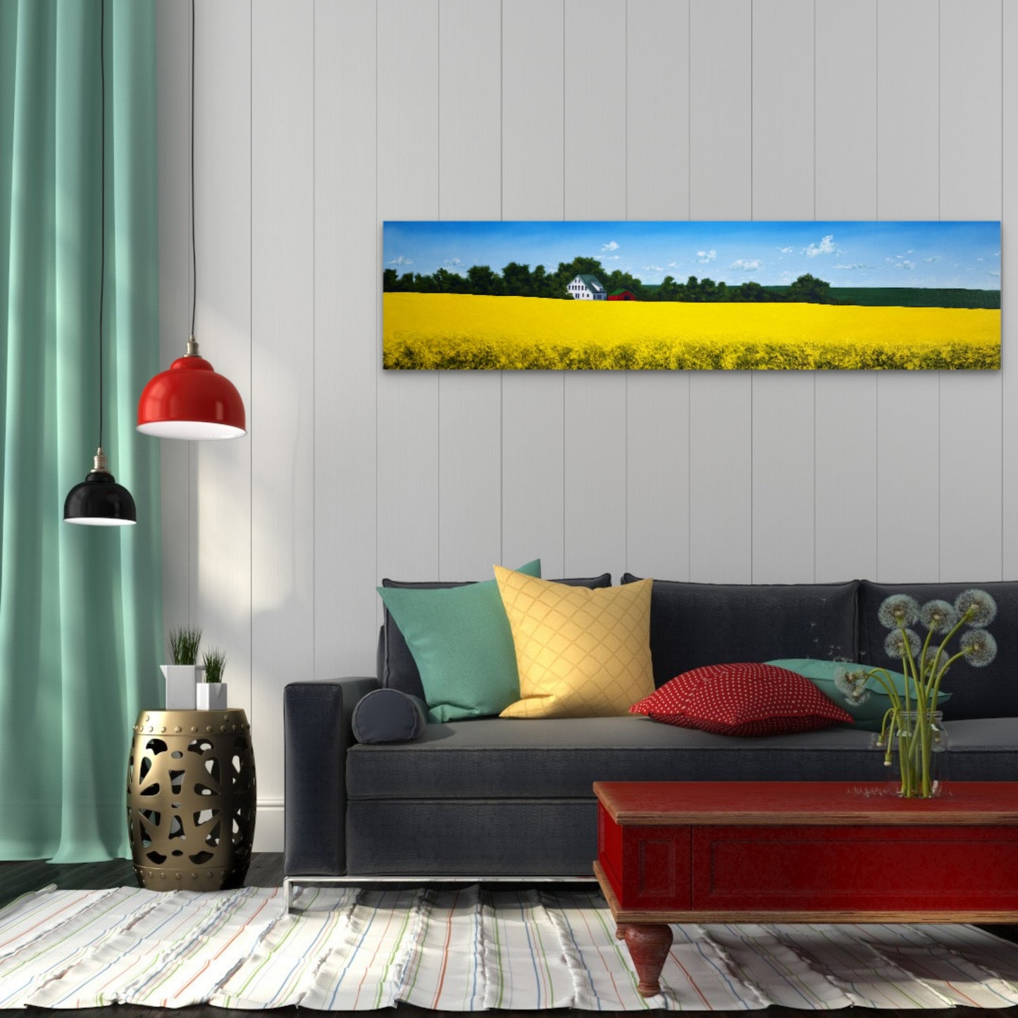 Living room with a couch, colorful pillows, and a painting of a yellow field on the wall.