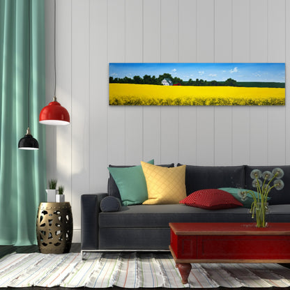 Living room with a couch, colorful pillows, and a painting of a yellow field on the wall.