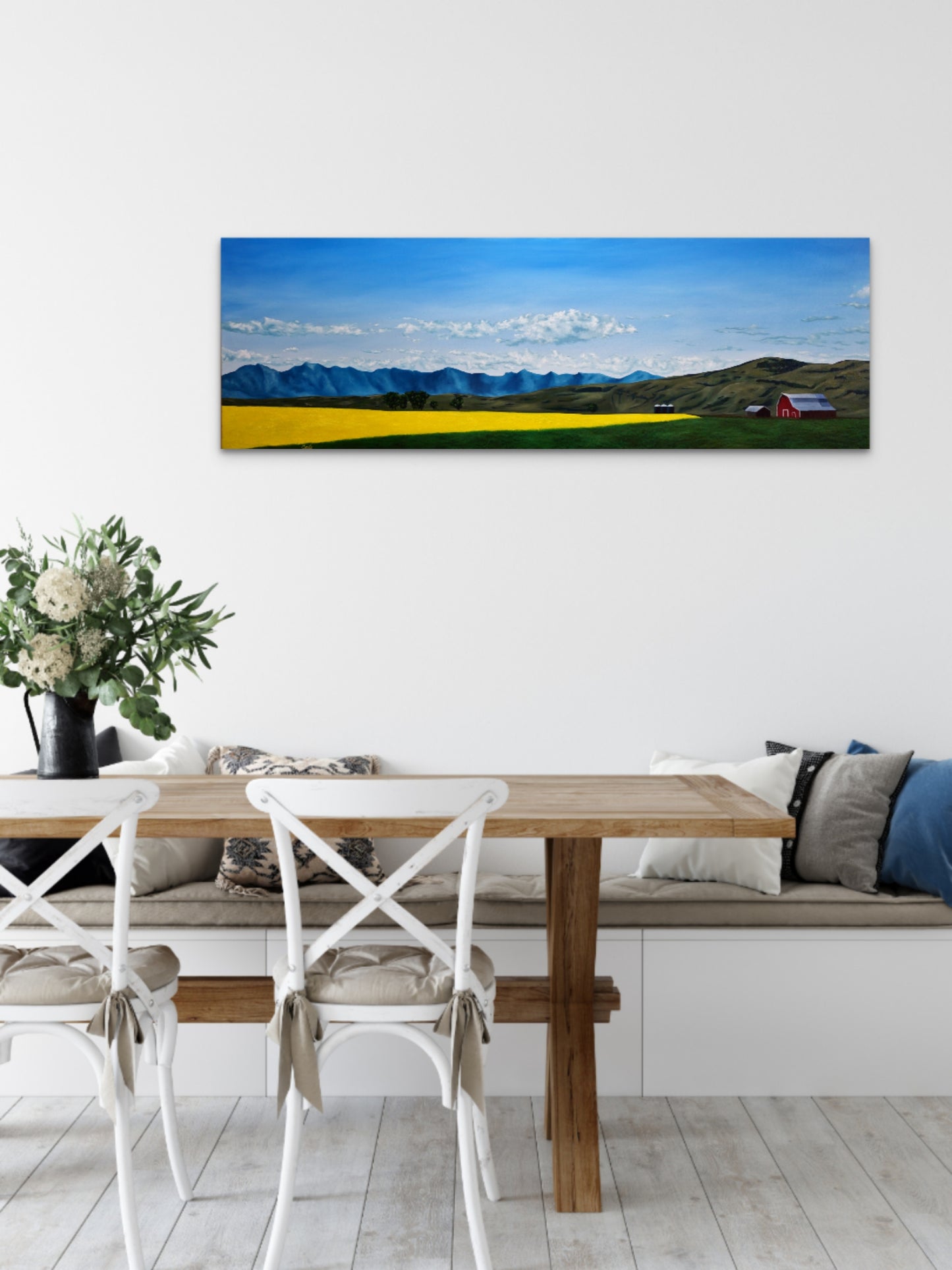 Dining room with a large landscape painting on the wall