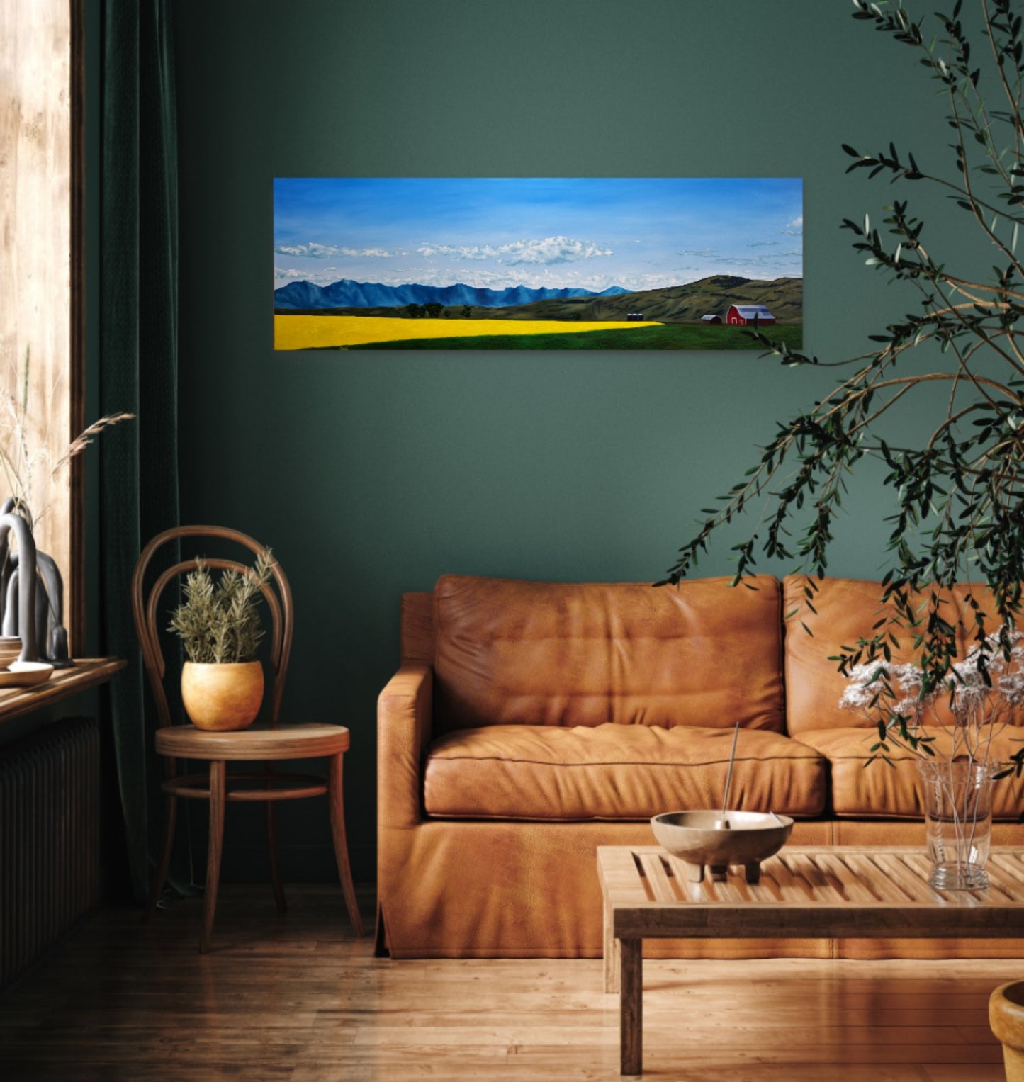 Living room with a brown leather sofa, wooden coffee table, and a large wall-mounted painting of a landscape.
