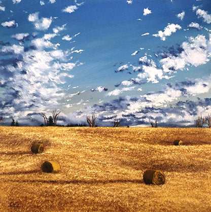 a painting of 4 bales scattered around a golden fall field, with big clouds coming over the horizon