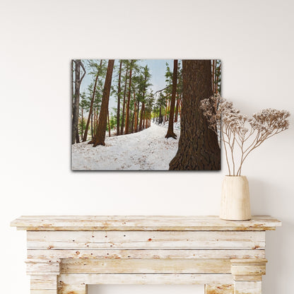 Framed print of a snowy forest scene on a wall above a wooden console table.